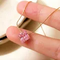 Close-up of elegant pink square zircon pendant on a gold titanium steel chain - N872 (Pink Rhinestone) / Pink