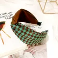 Close-up view of vintage teal and brown houndstooth patterned knotted headband for women - Houndstooth Cross Knot / Peacock Green
