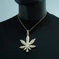 Close-up of iced out marijuana leaf pendant on a gold rope chain hip hop necklace - Necklace Set / Gold