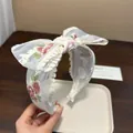 Elegante fascia per capelli in pizzo bianco con ricami floreali e grande fiocco - Cerchietto con Nodo / Bianco