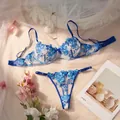 Detailed view of blue floral embroidered sheer lingerie set with romantic lifestyle props - S / Top And Bottom / Blue