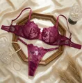 Detailed view of the intricate rose embroidery on the sheer lace lingerie set - S / Top And Bottom / Fuschia