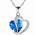 Detailed view of an elegant heart-shaped pendant with a blue crystal and water wave chain - Blue