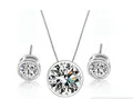 Macro detail of brilliant-cut AAA round zircon in bezel-set necklace and earrings - White