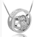 Close-up detail of silver rotating heart pendant necklace with sparkling Austrian crystals - White Zircon Style / K9 / Silver