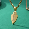 Gold titanium steel arrowhead pendant necklace with inset stones on green background. - Gold Spearhead Pendant Necklace / With Pearl Chain