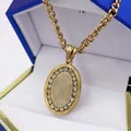 Gold oval rhinestone pendant necklace featuring Our Lady of Guadalupe displayed in a gift box - Necklace (With Chain) / Gold