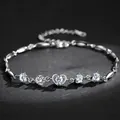 Macro detail of elegant silver heart bracelet featuring sparkling clear zirconia stones - White