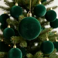 Macro view of dark green flocked Christmas ball with premium velvet texture on tree - 3cm / Dark Green