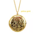 Detailed view of yellow gold stainless steel round locket necklace with floral pattern - Gold
