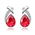 Detail of silver stud earrings featuring a red teardrop crystal and pavé accents - Red