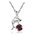 Detailed shot of a silver dolphin pendant necklace featuring a large red crystal - Red