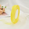 Detail view of semi-transparent yellow chiffon ribbon for elegant DIY gift packaging - 450m/Roll (0.6-0.7cm Wide) / Yellow