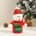 Close-up view of a plush Christmas snowman gift bucket with 'WELCOME' embroidery. - Snowman Welcome