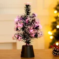 Detail of a mini fiber optic Christmas tree with pink glowing lights on wooden table. - Color Box / 30CM Snowflake Leaf Fiber Optic Tree Battery Type