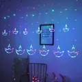 Detail of colorful Diya-shaped LED curtain lights illuminating a bedroom wall - Plug-in 220V EU Version (8-Function) / Anchor Curtain Light Multicolor
