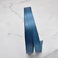 Premium teal blue polyester satin ribbon roll on elegant white marble background - Peacock Blue Style (D3-8134) / 1cm Wide (100 Yards/Roll) / Teal