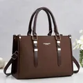 Front view of large brown leather handbag with gold-tone hardware detail - Coffee