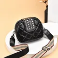 Small black crossbody bag featuring silver rivets and a wide striped adjustable strap. - Black
