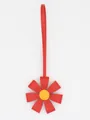 Close-up of a red PU leather flower bag charm with a yellow center on white background - Red