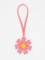 Detail view of a pink 3D PU leather flower bag charm with a yellow center accent - Pink