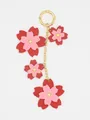 Detailed view of PU leather cherry blossom flowers on a gold chain keychain. - Red Pink Sakura (22437)
