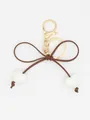 Detailed view of an elegant brown leather bow keychain with cute white heart charms - White Heart With Brown Rope