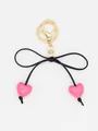 Detailed close-up of cute macaron pink heart beads and black bow on a gold keychain clasp - Pink Heart With Black Rope Style 2