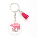Macro view of clear acrylic keychain featuring pink Mama Bear design and hot pink tassel - Mama Bear Polar Bear