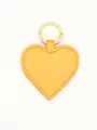 Detailed close-up of a vibrant yellow glitter heart PU leather magnetic hat clip with ring - Glitter Heart Charm / Yellow