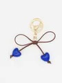 Detail of a cute blue heart and brown bow keychain charm with a gold metal clasp - Blue Heart With Dark Brown Rope