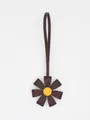Premium brown PU leather flower bag charm with 3D petals and vibrant yellow center - Brown