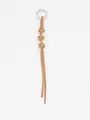 Close-up of handmade braided cowhide leather keychain with three knots and metal ring - Tan