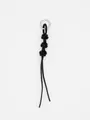 Detailed view of handwoven black leather keychain with knotted design and silver ring - Black
