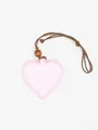 Close-up view of a pink heart-shaped PU leather glasses clip with a brown neck strap - Light Pink