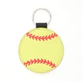Detailed close-up of a yellow faux leather keychain featuring red softball stitching. - Softball