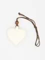 Macro view of a cream heart-shaped PU leather glasses clip with a brown lanyard - Off White