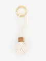 Close-up of a handmade white PU leather woven ball keychain with a rustic wood bead detail. - Off-White (22587)