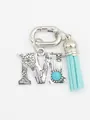 Detail of silver letter M charm with turquoise stone and light blue tassel - Letter M