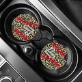 Macro view of leopard print car coasters with baseball stitching in a vehicle cup holder - Leopard Baseball Heart (80099) / Two-Piece Set