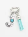Detailed view of ethnic turquoise letter J charm with light blue suede tassel accessory - Letter J