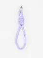 Detail of a minimalist lilac purple PU leather braided keychain with silver ring. - Lavender