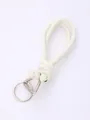 Detail view of a handmade white knotted PU leather keychain with silver hardware. - Off-White (20836)