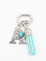 Detailed view of bohemian silver letter A keychain with turquoise and blue tassel - Letter A