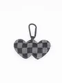 Detailed view of a checkered denim double heart keychain pendant with black metal clip - Black and White Checkered Denim