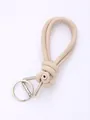 Detailed macro view of beige hand-woven PU leather phone lanyard with silver metal clasp - Apricot (20842)