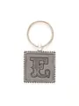 Detailed view of vintage decorative letter E embossed on silver square leather keychain - 20720