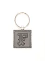 Close-up of personalized zinc alloy keychain with embossed leather letter F detail. - 20721