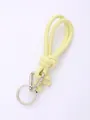 Close-up of yellow hand-woven PU leather keychain with silver metal clip and ring - Bright Yellow (20851)