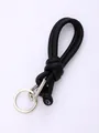 Close-up detail of a minimalist black knotted PU leather phone lanyard with metal ring - Black (20848)